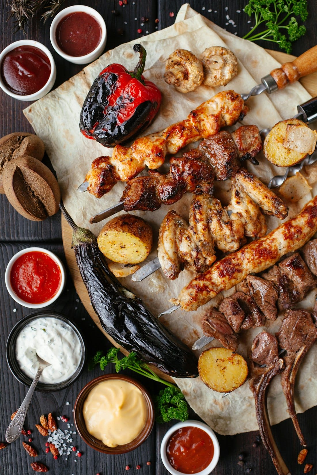 A generous Afghan spread of grilled meats, bread and sides laid out to share